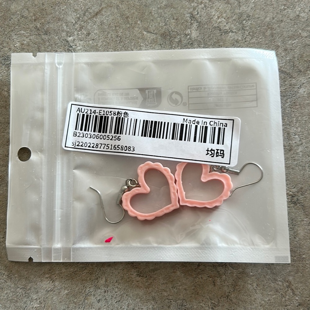 Brand new cute French hook earrings. Pink plastic heart measures 3/4”.